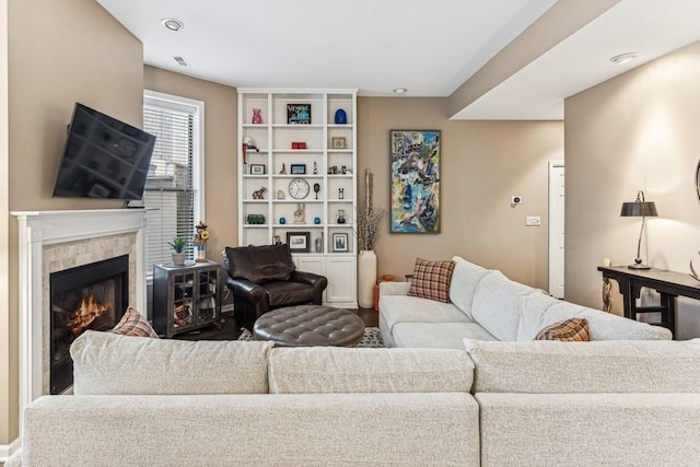 living area with a tile fireplace