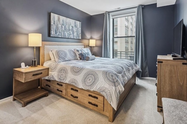 carpeted bedroom featuring baseboards