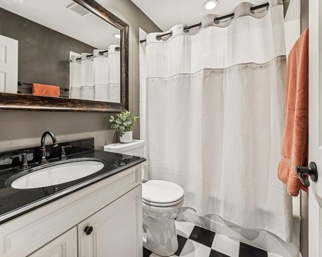 bathroom featuring toilet, visible vents, shower / bath combo with shower curtain, and vanity