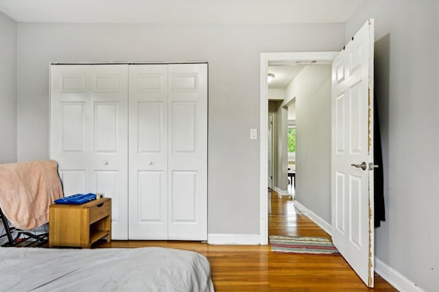 bedroom with hardwood / wood-style floors and a closet