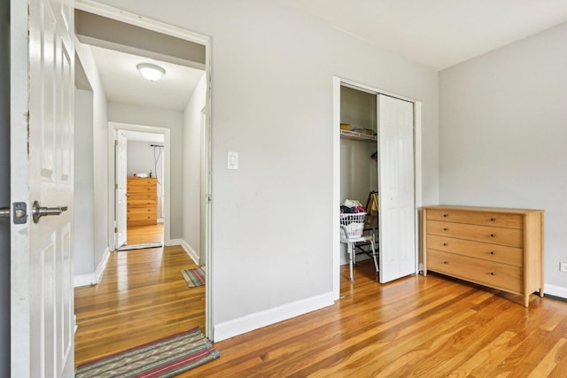 unfurnished bedroom with hardwood / wood-style flooring and a closet