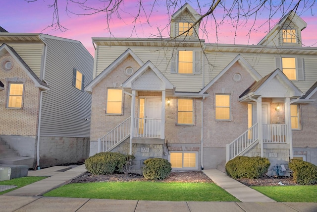 townhome / multi-family property featuring brick siding