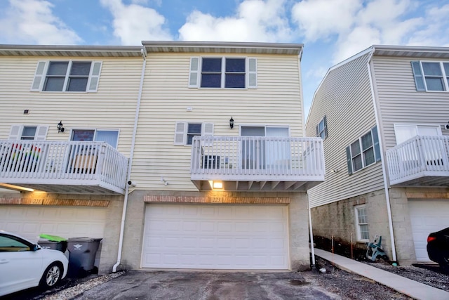 back of property with driveway and an attached garage