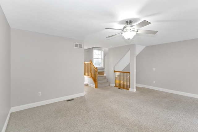 additional living space featuring a ceiling fan, carpet flooring, visible vents, and baseboards