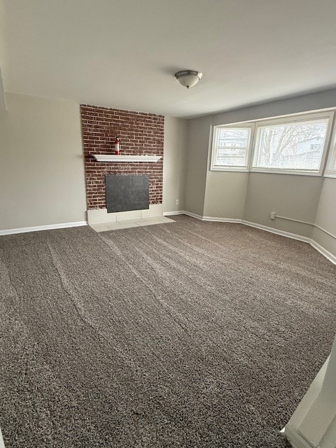 unfurnished living room featuring carpet flooring and a fireplace