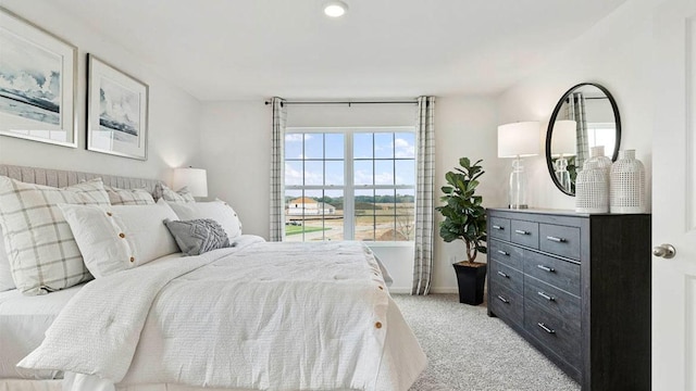 bedroom featuring light carpet and baseboards