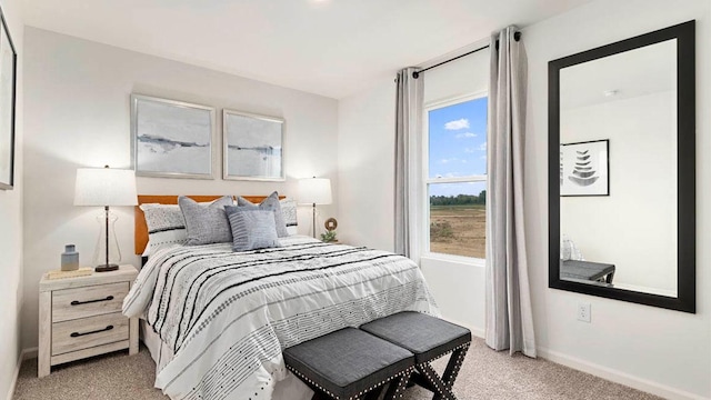 bedroom featuring light carpet and baseboards