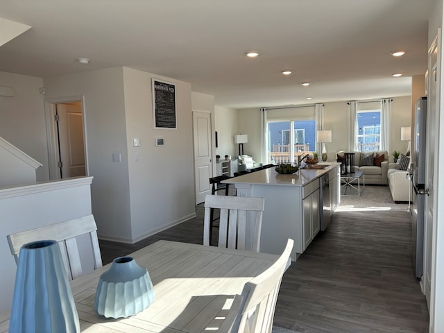 kitchen with sink, dark wood-type flooring, and a center island