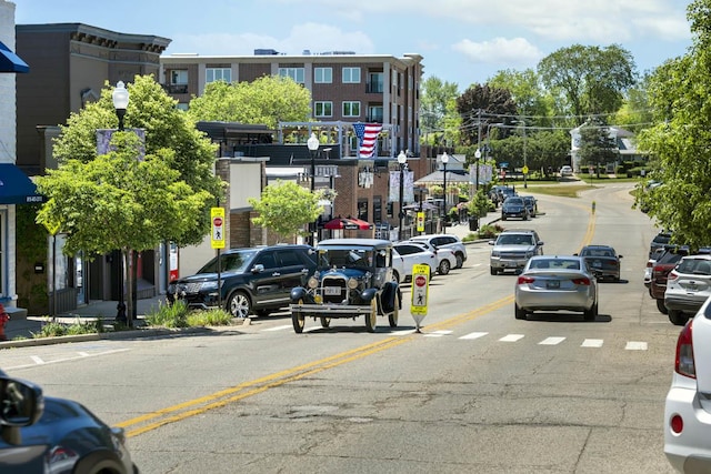 view of street featuring traffic signs, curbs, and street lights