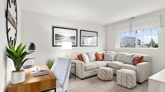 carpeted living area featuring visible vents