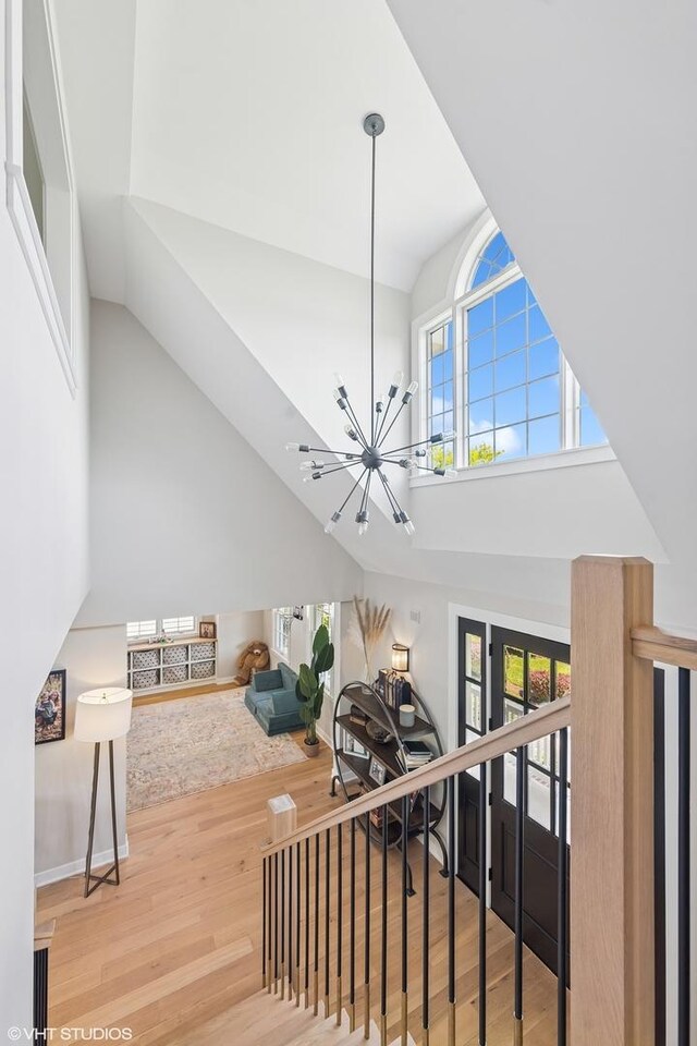 37580 N Fairfield Rd, Lake Villa, IL 60046 - stairway featuring a chandelier, wood finished floors, and high vaulted ceiling