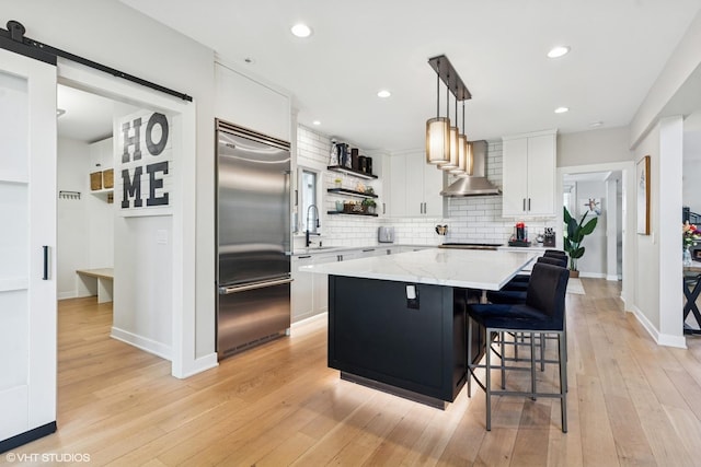 37580 N Fairfield Rd, Lake Villa, IL 60046 - kitchen featuring appliances with stainless steel finishes, wall chimney range hood, open shelves, a sink, and backsplash