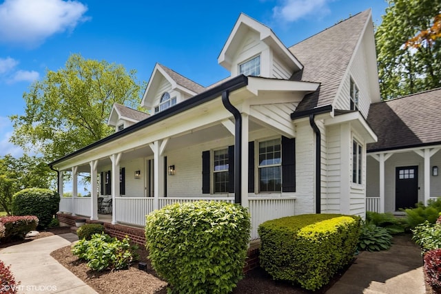 37580 N Fairfield Rd, Lake Villa, IL 60046 - view of front facade with a porch, a shingled roof, and brick siding