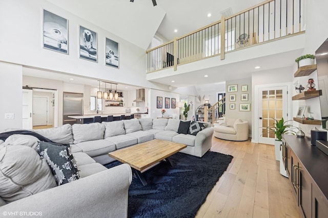 37580 N Fairfield Rd, Lake Villa, IL 60046 - living room featuring stairway, a towering ceiling, light wood-type flooring, and recessed lighting
