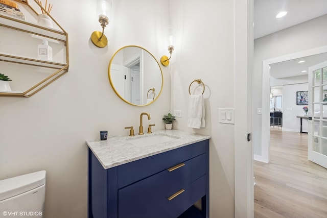 37580 N Fairfield Rd, Lake Villa, IL 60046 - bathroom featuring vanity, toilet, wood finished floors, recessed lighting, and baseboards
