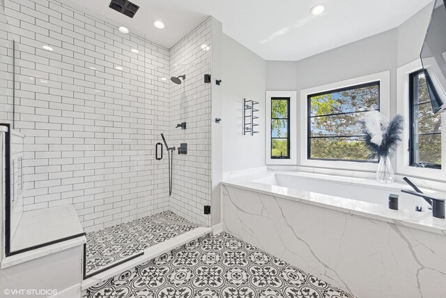 37580 N Fairfield Rd, Lake Villa, IL 60046 - bathroom featuring a bath, a shower stall, tile patterned floors, and recessed lighting