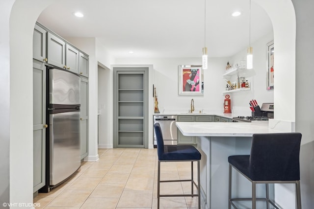 37580 N Fairfield Rd, Lake Villa, IL 60046 - kitchen with appliances with stainless steel finishes, a sink, a peninsula, light countertops, and arched walkways