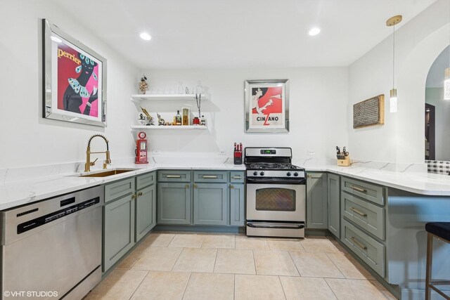 37580 N Fairfield Rd, Lake Villa, IL 60046 - kitchen with appliances with stainless steel finishes, a sink, arched walkways, open shelves, and light stone counters