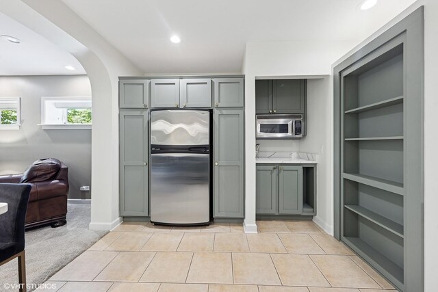 37580 N Fairfield Rd, Lake Villa, IL 60046 - kitchen featuring appliances with stainless steel finishes, gray cabinets, recessed lighting, arched walkways, and open floor plan