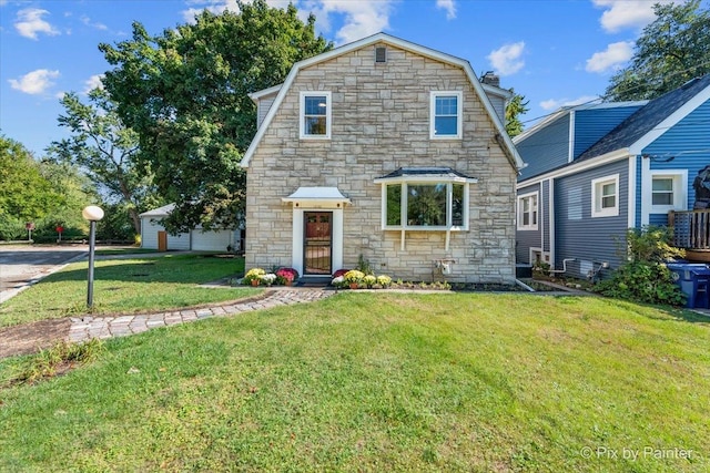 view of front of home with a front lawn and a gambrel roof