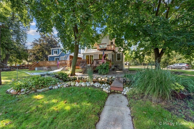 view of front facade featuring a front yard, fence, and a deck