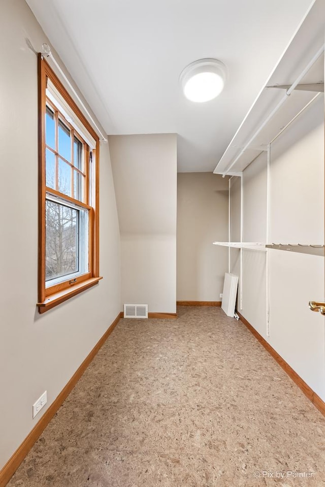 bonus room featuring lofted ceiling, baseboards, visible vents, and carpet flooring