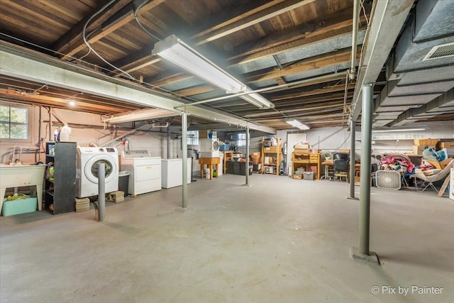 basement with visible vents and separate washer and dryer