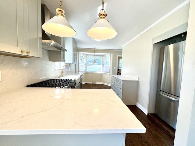 kitchen featuring sink, stainless steel fridge, gray cabinetry, hanging light fixtures, and light stone countertops