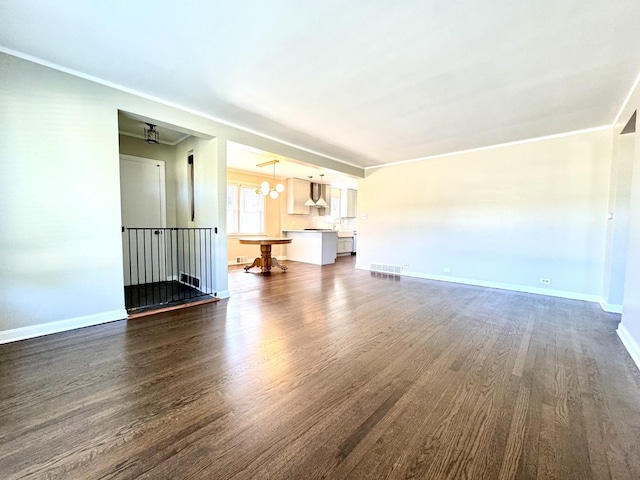 unfurnished living room with ornamental molding and dark hardwood / wood-style flooring