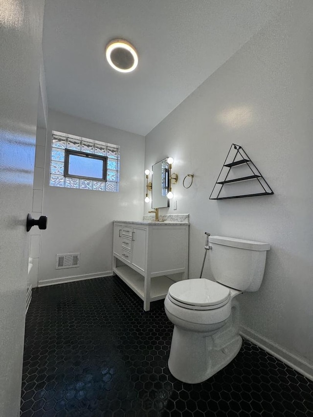 bathroom featuring vanity and toilet