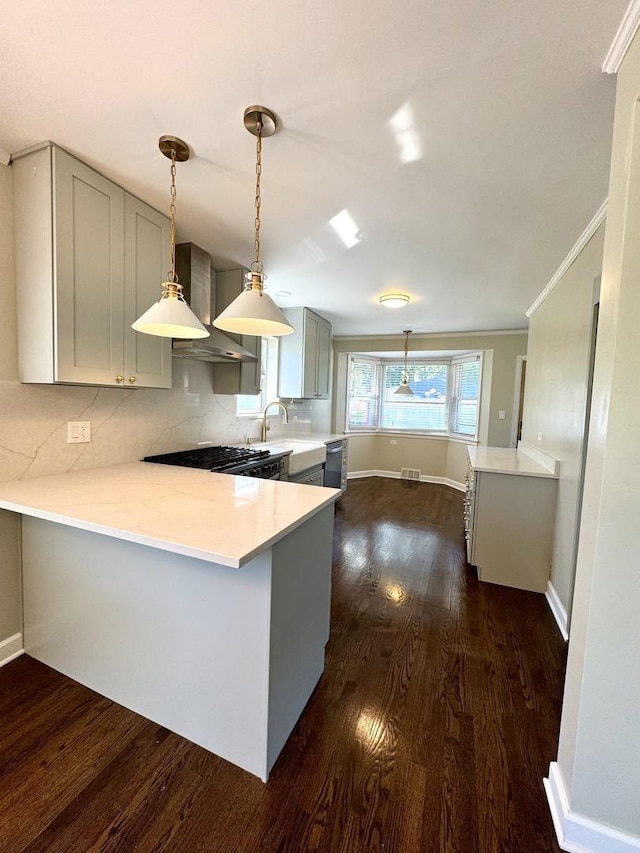 kitchen featuring dark hardwood / wood-style floors, gray cabinets, kitchen peninsula, and wall chimney exhaust hood