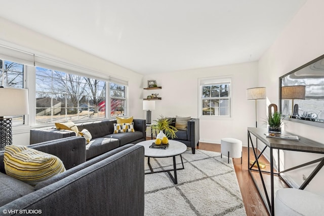 living room featuring light wood-type flooring and baseboards