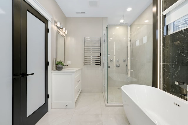 bathroom featuring radiator heating unit, plus walk in shower, and vanity