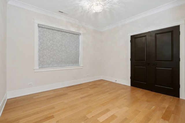 unfurnished bedroom with hardwood / wood-style flooring and ornamental molding