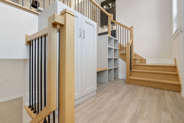 stairs featuring hardwood / wood-style floors