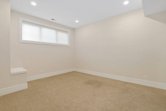 unfurnished room featuring light carpet