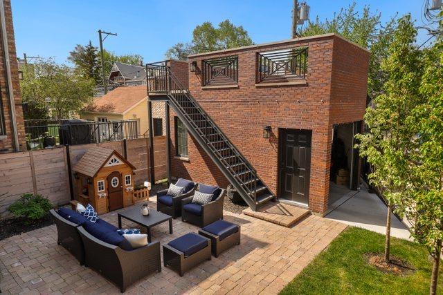 rear view of property featuring outdoor lounge area and a patio area