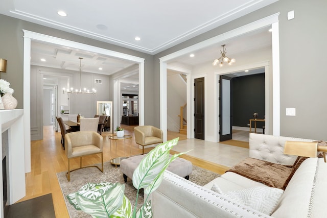 living room with crown molding, light hardwood / wood-style flooring, an inviting chandelier, beam ceiling, and coffered ceiling