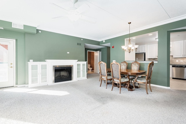 dining area with baseboards, a fireplace, visible vents, and light colored carpet