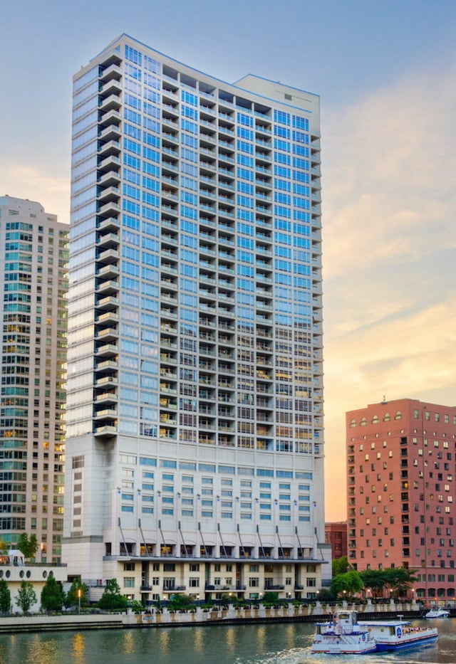 outdoor building at dusk featuring a water view