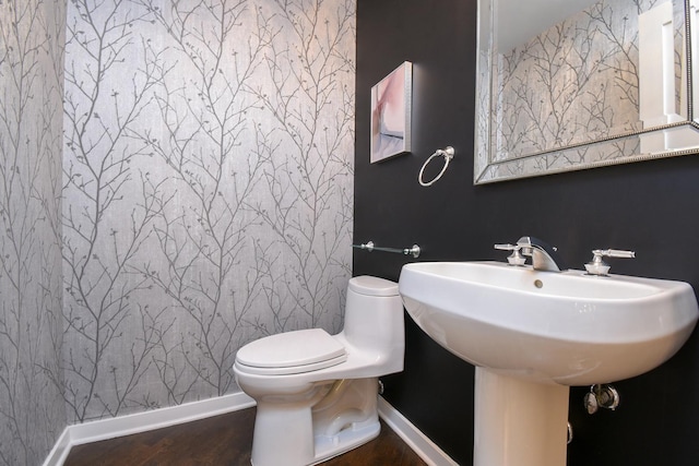 bathroom with hardwood / wood-style floors and toilet