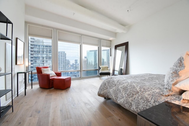 bedroom with access to exterior and light hardwood / wood-style floors