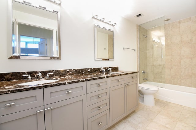 full bathroom with vanity, toilet, and tiled shower / bath combo