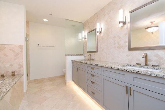 bathroom featuring tile walls, tile patterned flooring, vanity, walk in shower, and toilet