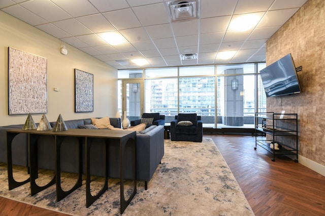 living room featuring a paneled ceiling, dark parquet floors, and floor to ceiling windows