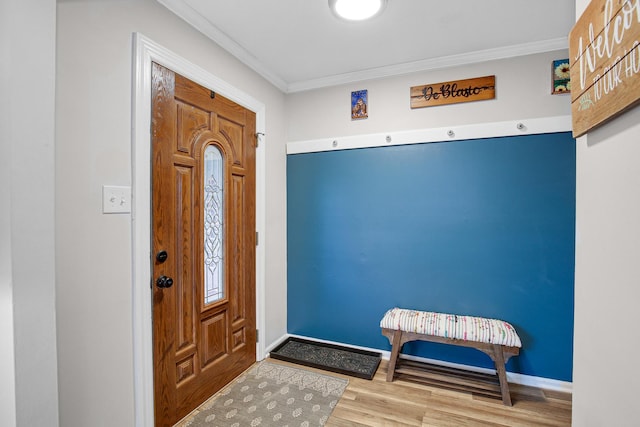 foyer with hardwood / wood-style floors and ornamental molding