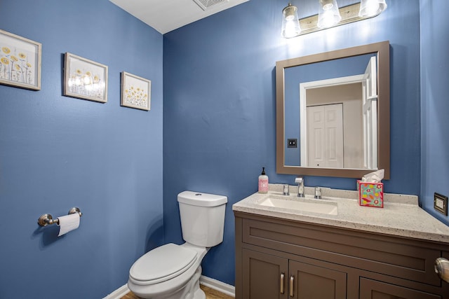 bathroom featuring vanity and toilet