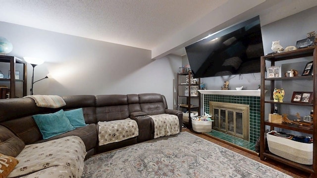 803 Irvine Rd Unit 803, Champaign, IL 61822 - living room with a tile fireplace, wood finished floors, a textured ceiling, and lofted ceiling