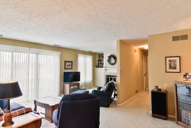 living room featuring light carpet and a textured ceiling