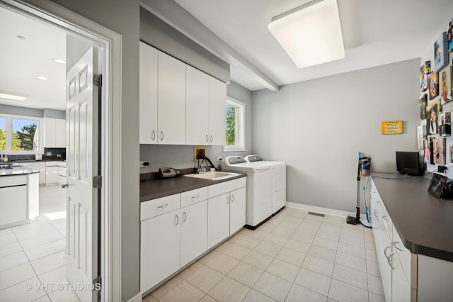 laundry area featuring cabinets, sink, washer and dryer, and light tile patterned floors